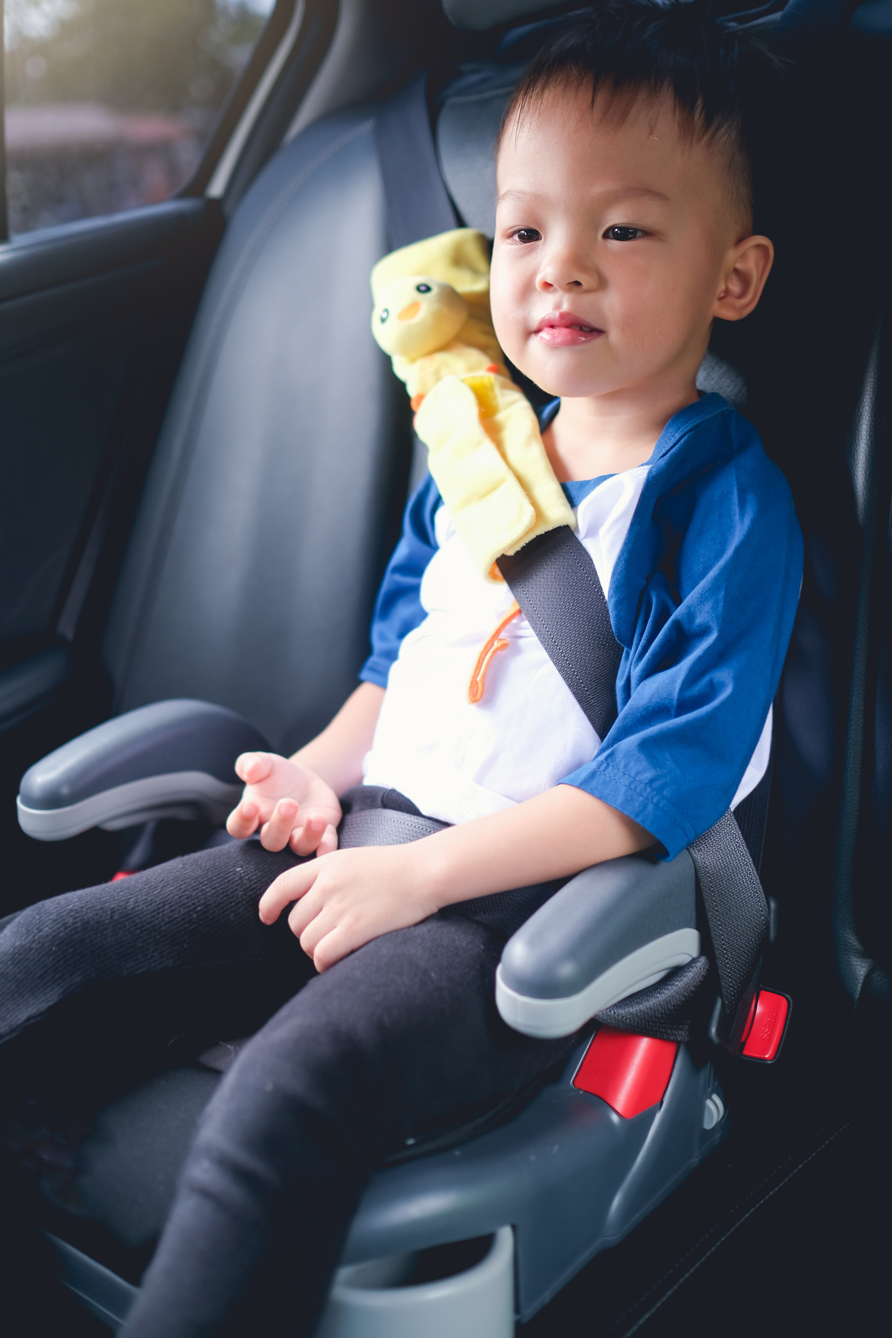 Asian 3 - 4 years old toddler boy child sitting in booster car seat, Happy traveling, Child passenger safety