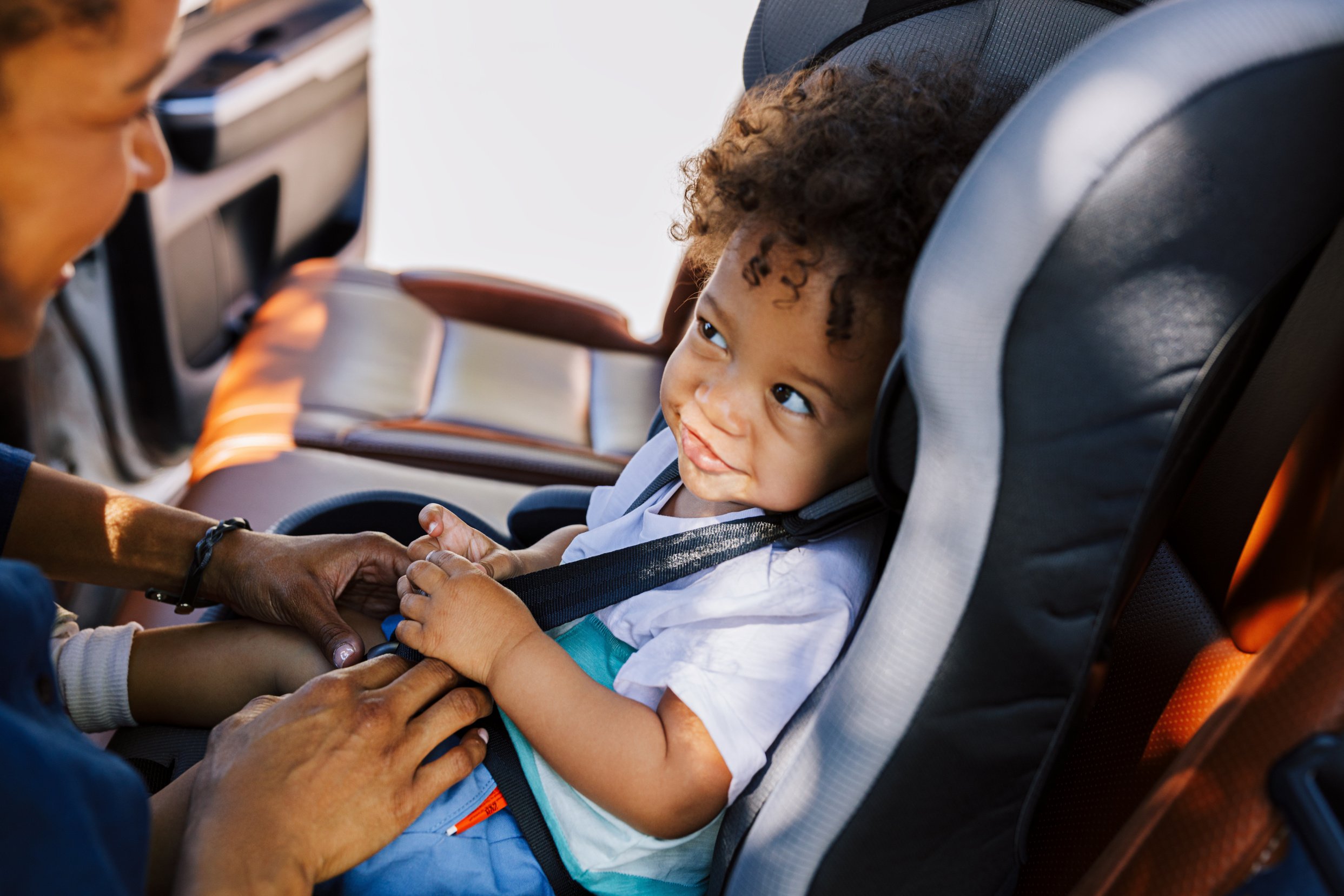 Dad Putting Son in a Car Seat